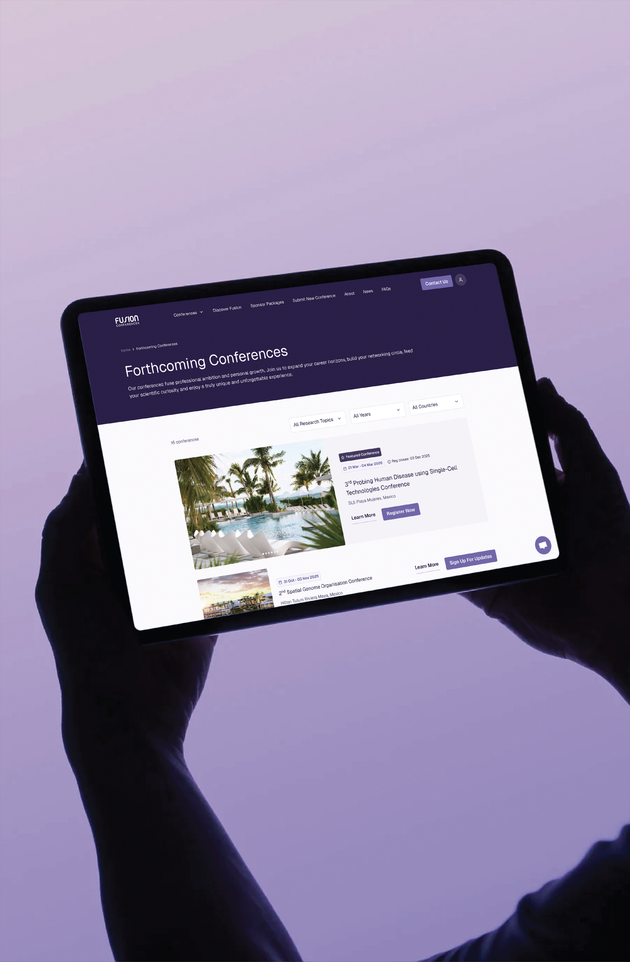 A person's hands are holding a tablet displaying a webpage titled 