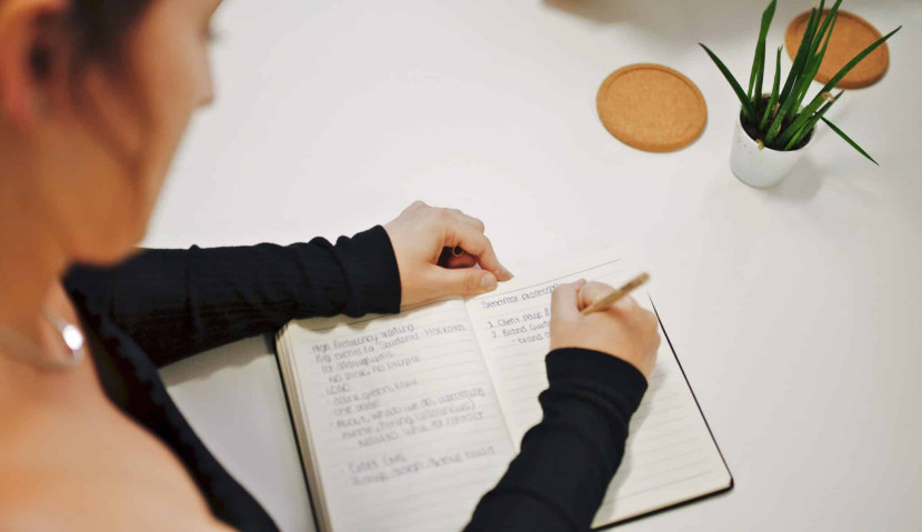 Woman writing on a notebook