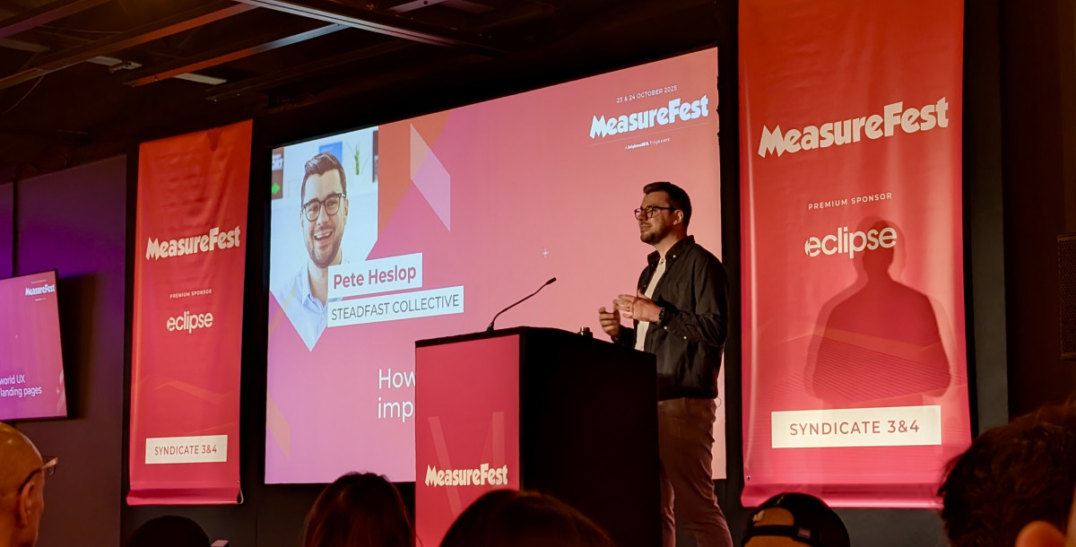 A speaker presents at MeasureFest, with a slide showing 