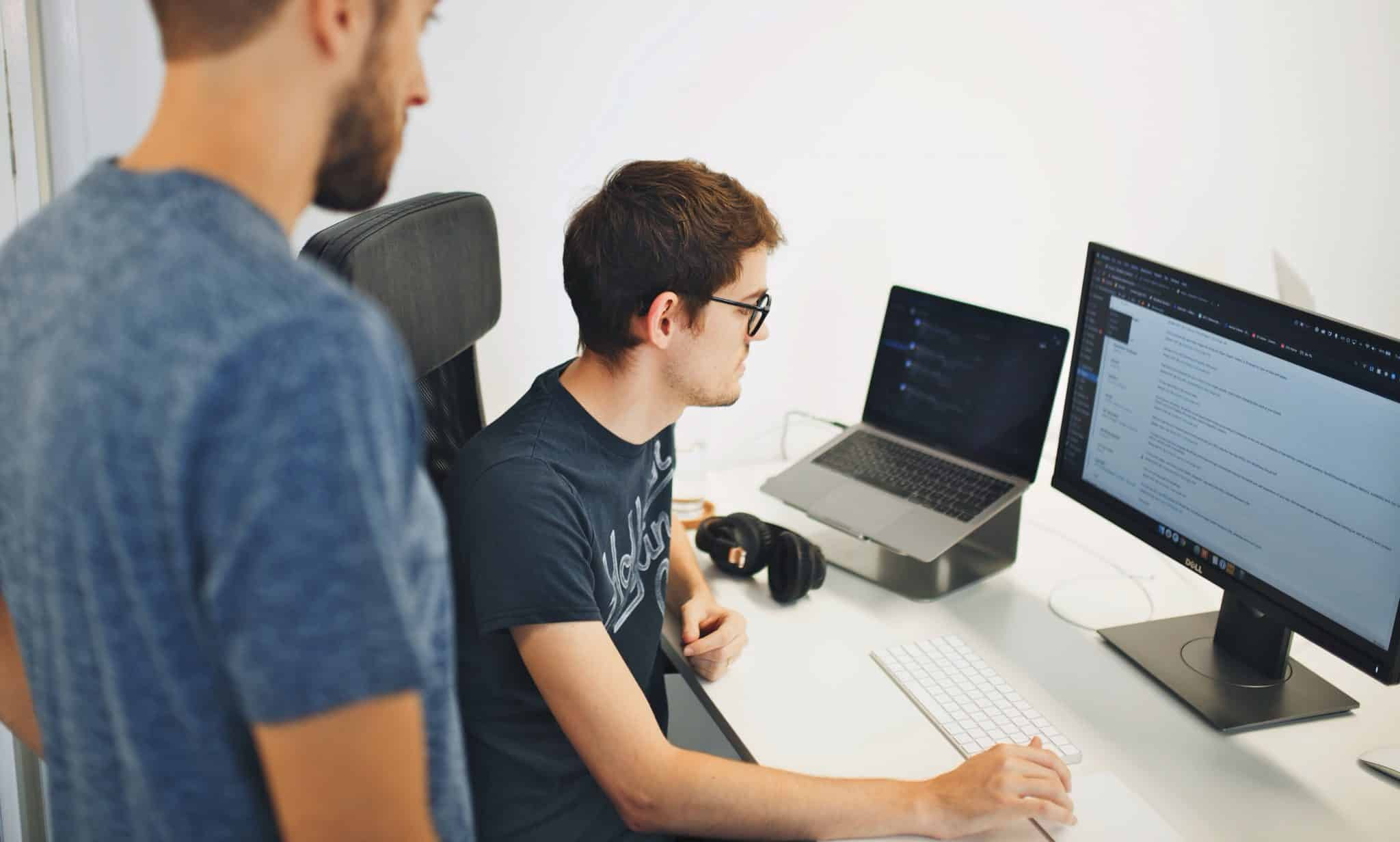 Two people looking at a PC screen