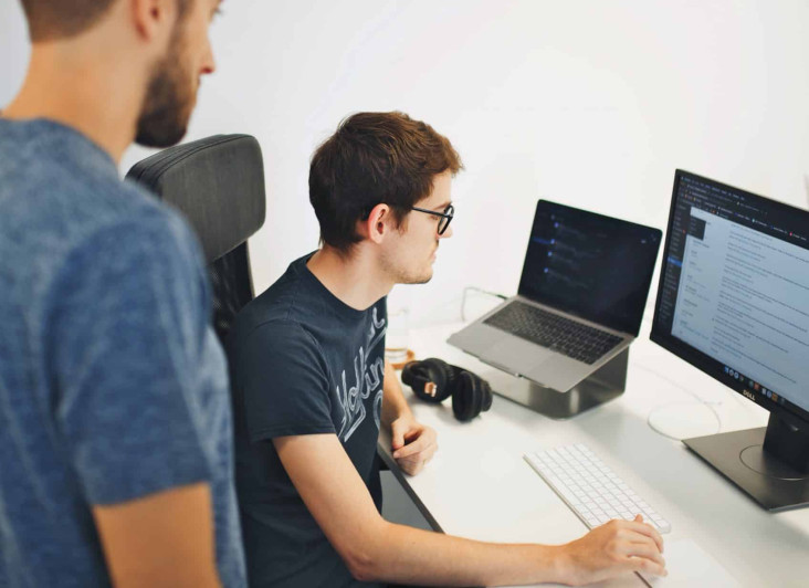 Two people looking at a PC screen