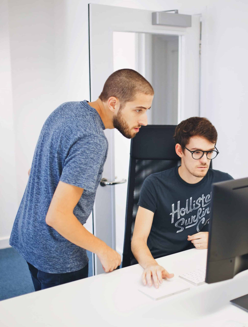 Two people looking at a PC screen