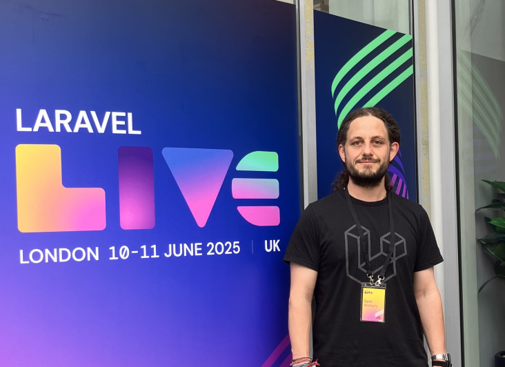 A developer standing outside the entrance to Laravel Live conference