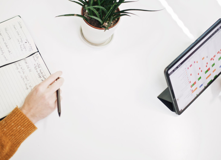 People discussing using a tablet and a notebook