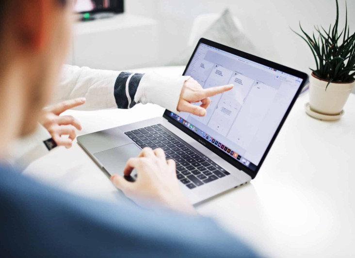 Finger pointing at a laptop screen